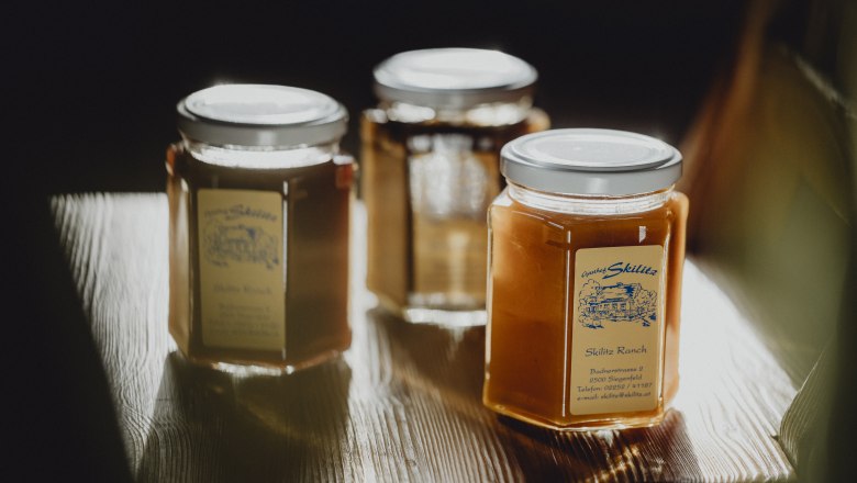 Takeaway restaurant, © Niederösterreich Werbung/Sophie Menegaldo Three jars of honey on a wooden table.
