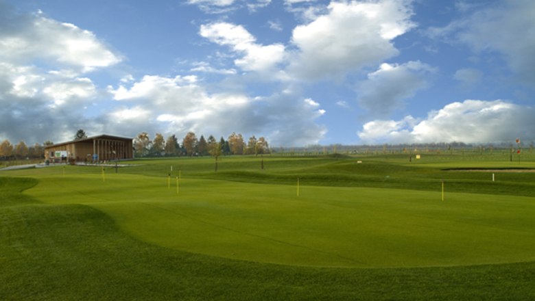 Guntramsdorf Golf Club, © C. Steiner Golf course with clubhouse and cloudy sky.