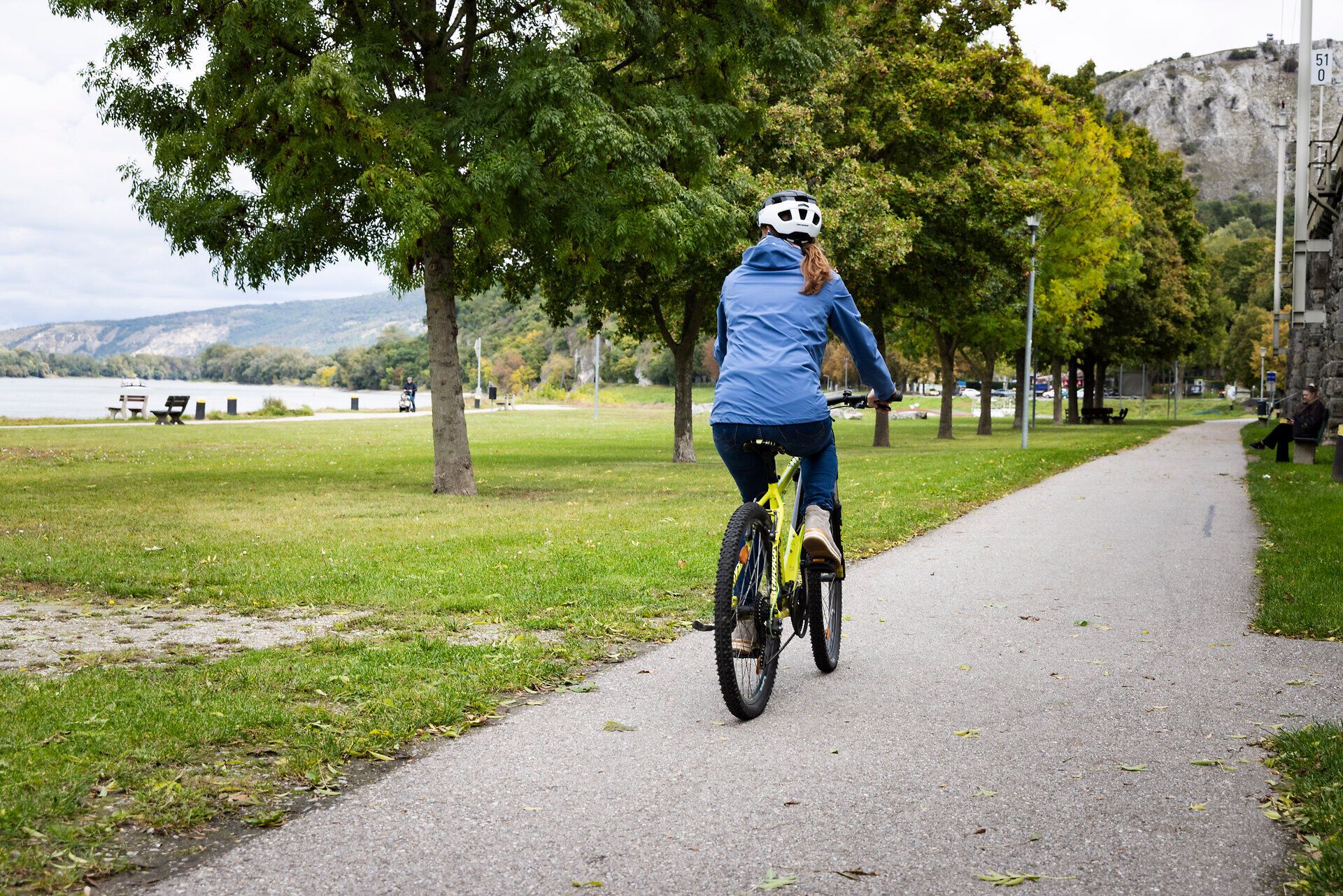 A woman rides her bike along the Danube cycle path near Hainburg.