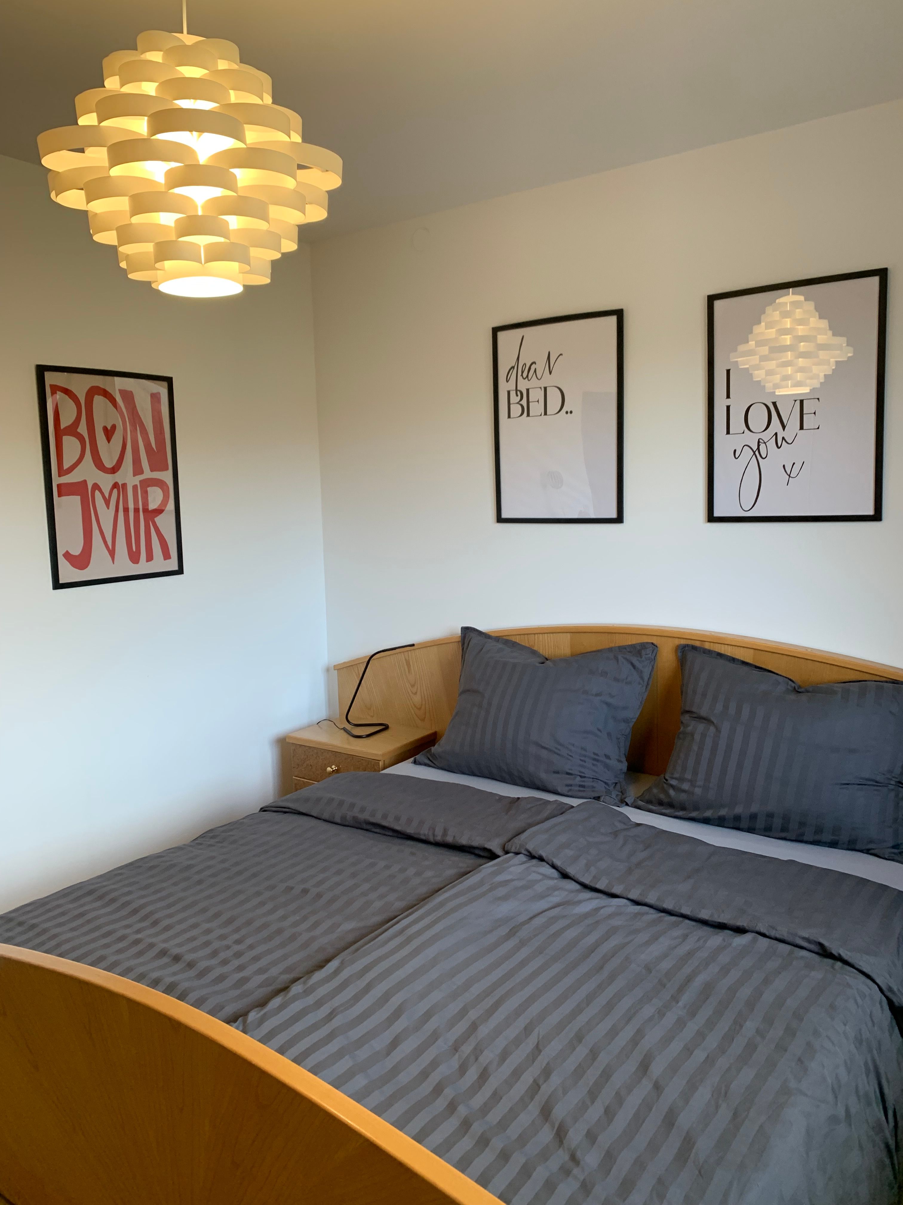 Room with double bed and pictures on the wall 