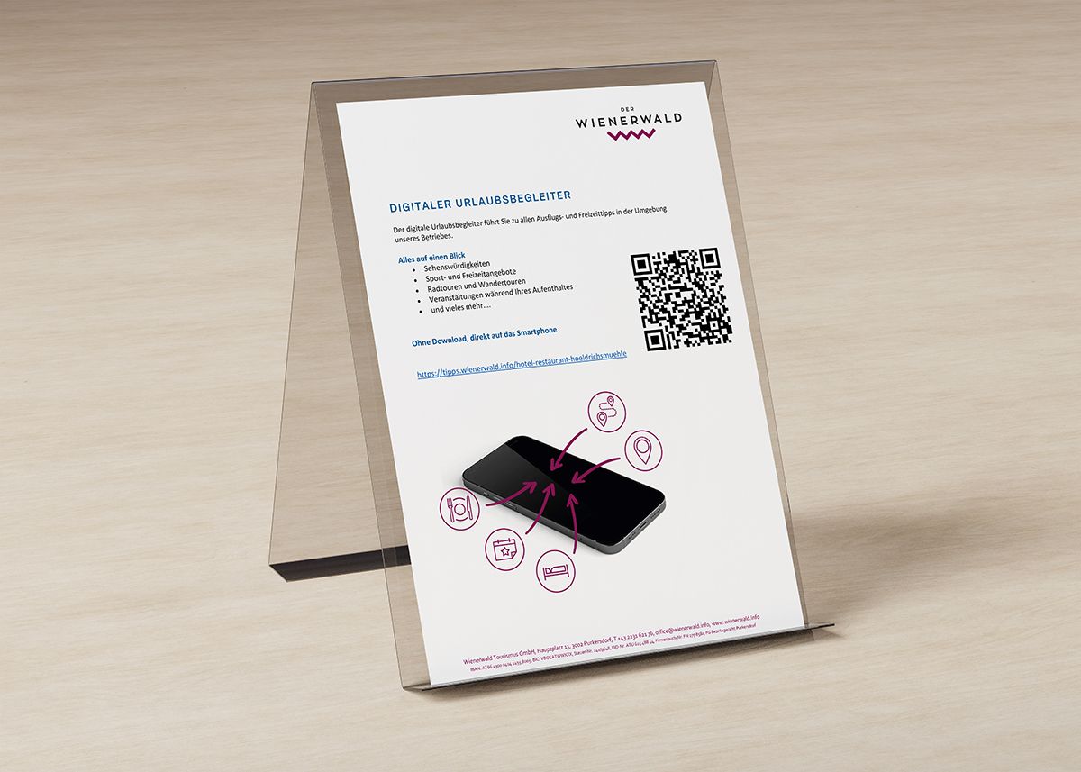 Ein Aufsteller mit einem Blatt Papier der Informationen zum digitalen Urlaubsbegleiter beinhaltet.