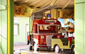 Carousel with fire engine and police car in the Bohemian Prater.