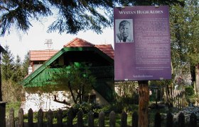 W.H. Auden memorial with information board in front of a house.