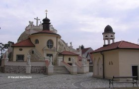 Church in Maria Lanzendorf with statues and bell tower.