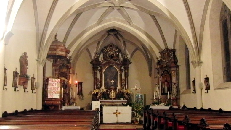 Interior view of a church with altar and pews.