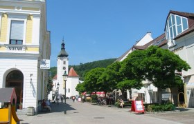 Hauptplatz in Purkersdorf mit Kirche und Geschäften.