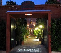 Entrance to an inner courtyard with illuminated path and plants.