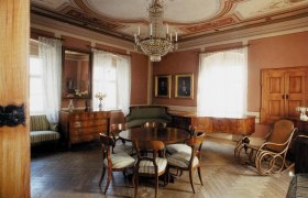 Elegant living room in the Hugo Wolf house with antique furniture and chandelier.