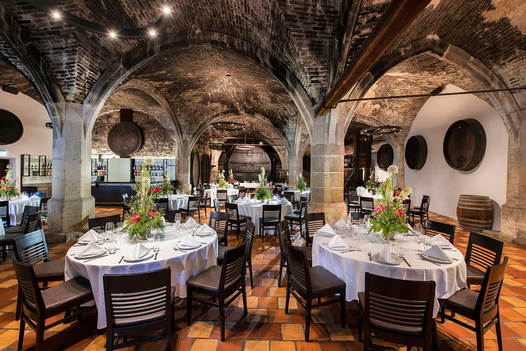 Elegant dining room with vaulted ceilings and decorated tables in Stift Klosterneuburg.